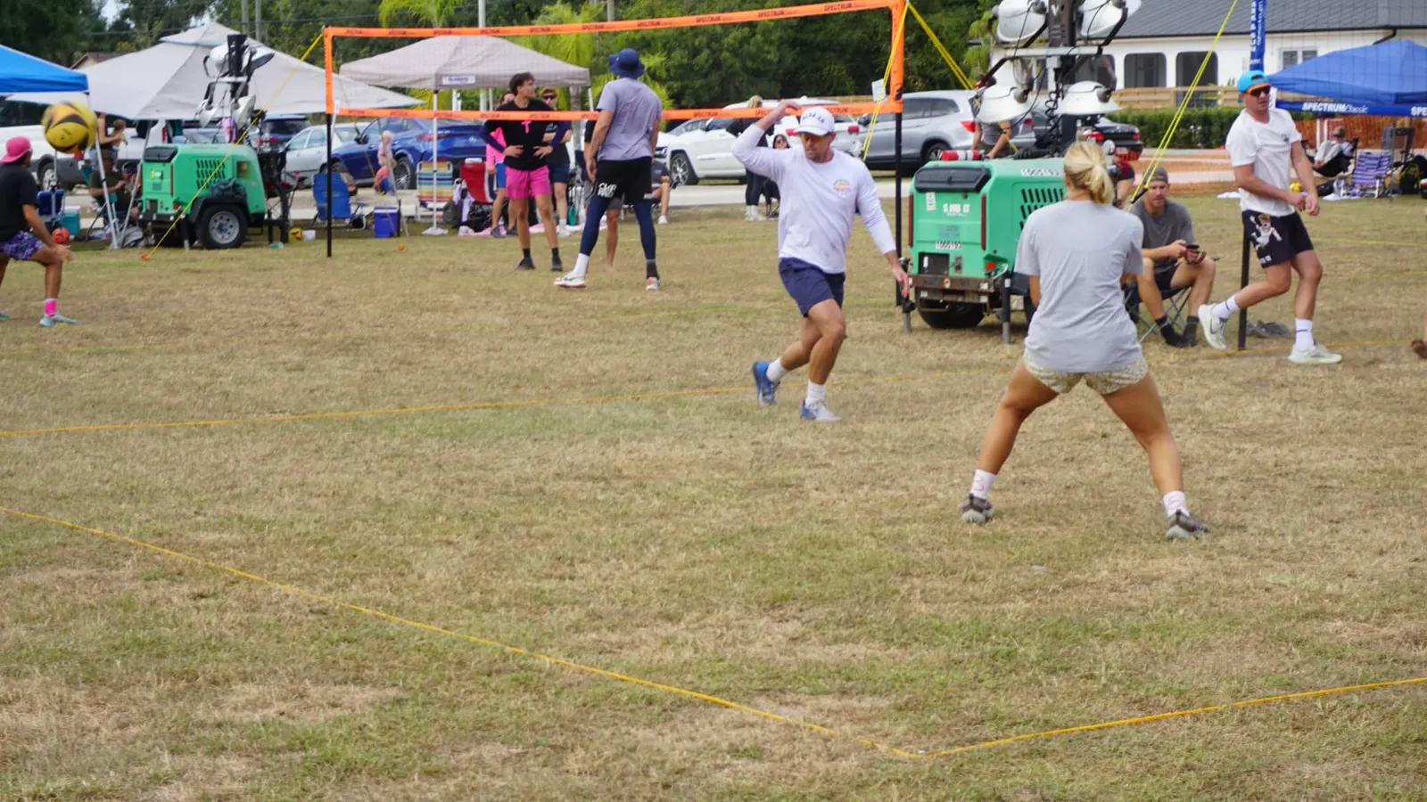 A coed team reacts to a ball sailing past the net